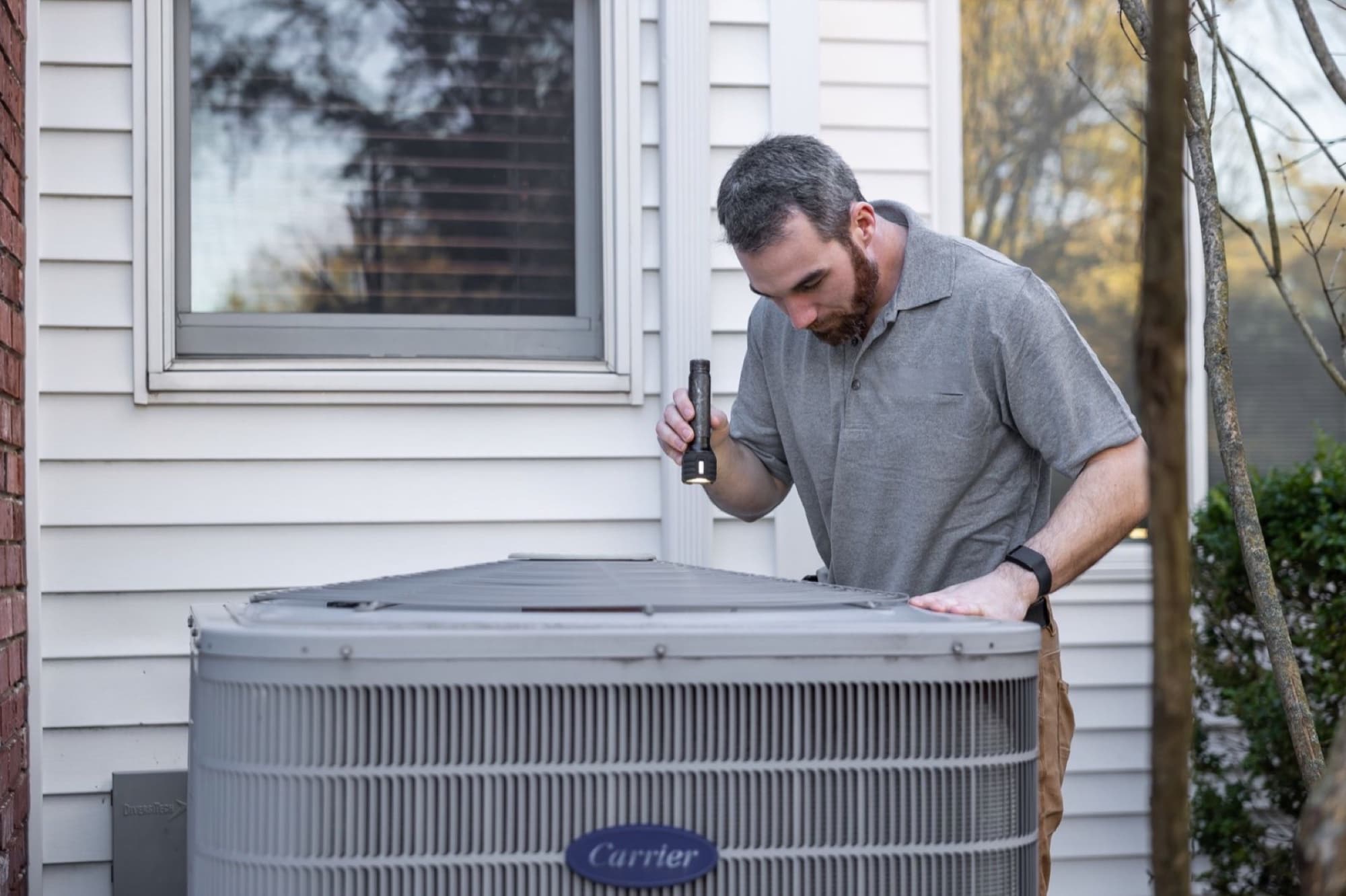 HVAC technician performing seasonal maintenance on a home heating system