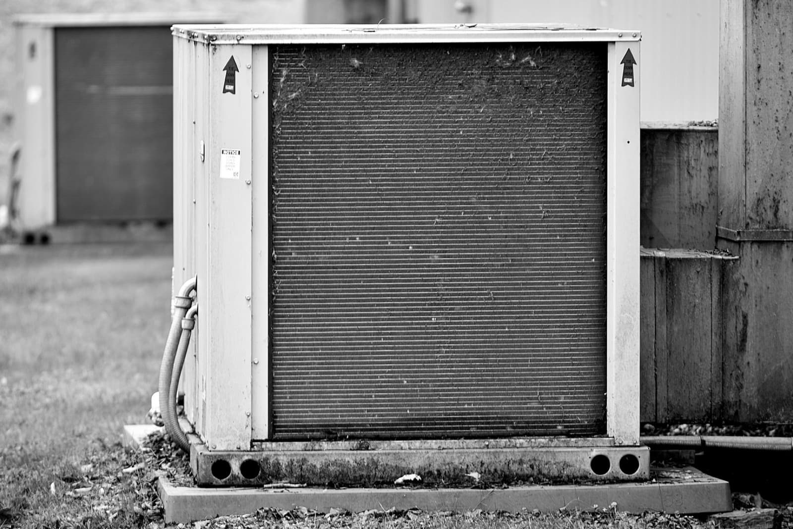 Aging outdoor AC condenser unit ready for replacement at a residential home